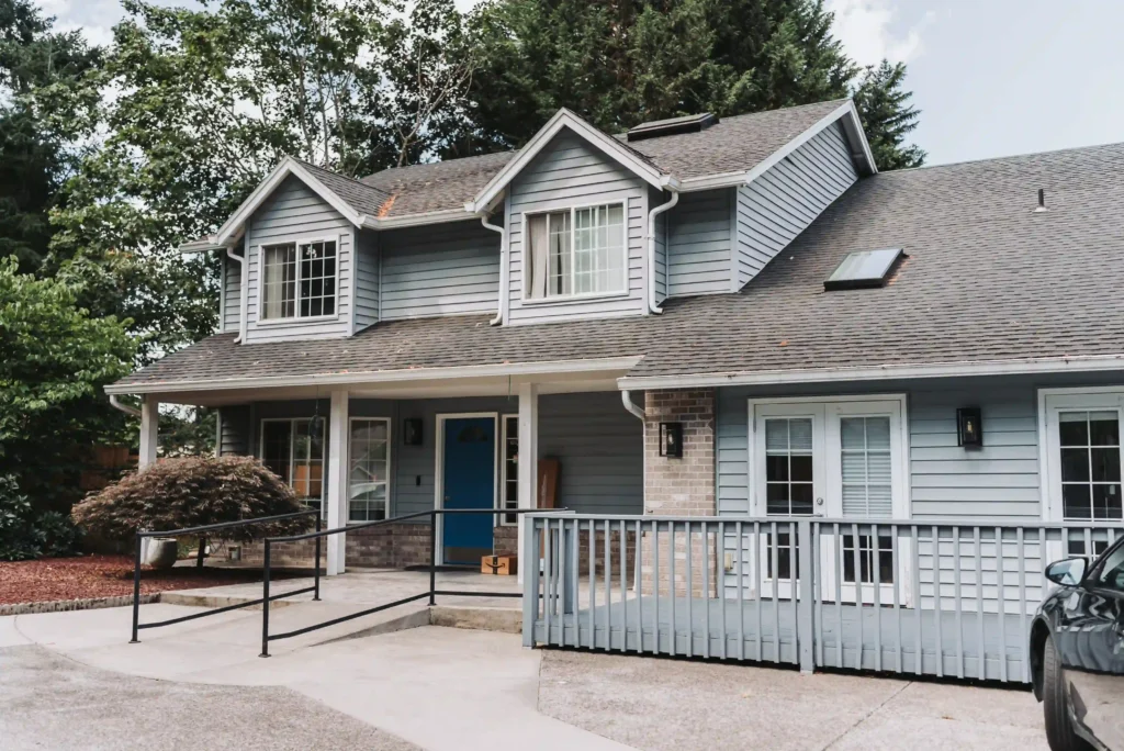 Front exterior view of a suburban two-story house with driveway.